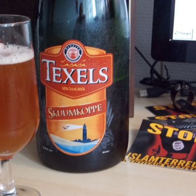 Foto van een geopende fles Texels bier met de naam Skuumkoppe en daarvoor een reeds ingeschonken fles.